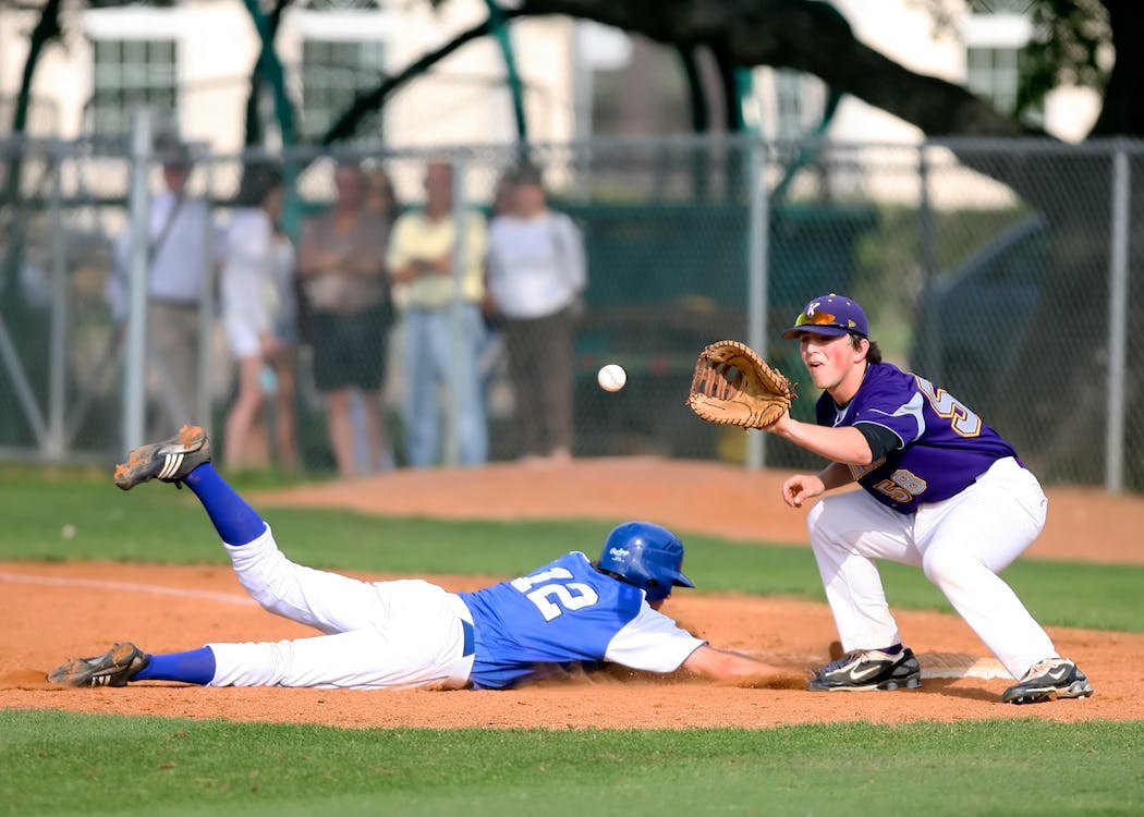 Two men playing high school baseball
